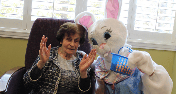 senior woman and easter bunny posing for photo