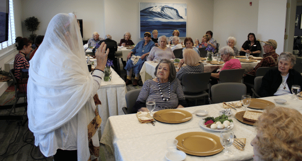 group of seniors participate in passover seder