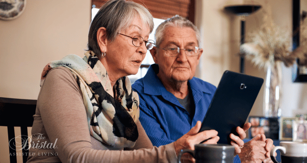 senior couple looking at iPad together