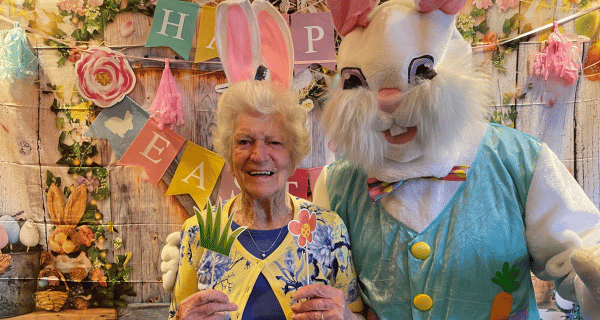 senior woman posing for picture with Easter Bunny