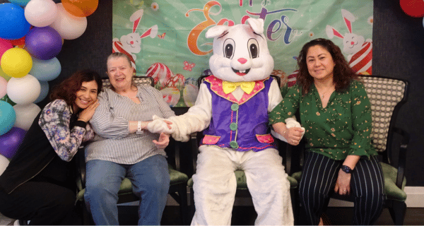 senior woman and family posing with Easter bunny