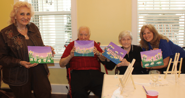 class attendees holding up finished artwork