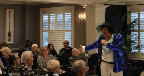 Elvis impersonator performing for group of seniors