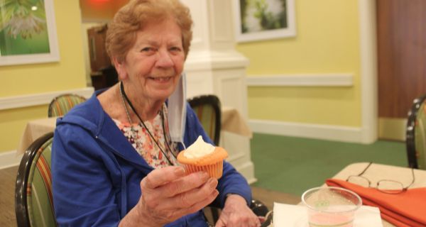 senior woman holding cupcake