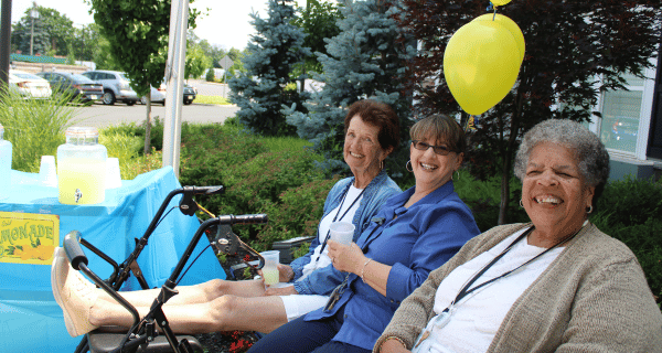 team member and senior women enjoying lemonade