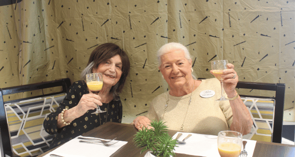 senior women enjoying mimosas