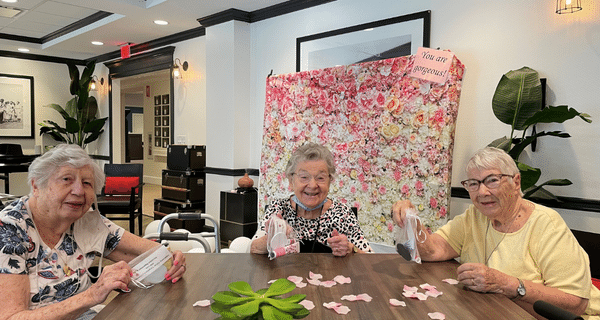 Group of senior women sitting at a table smiling 