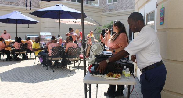 group of team members enjoying a cookout on a patio