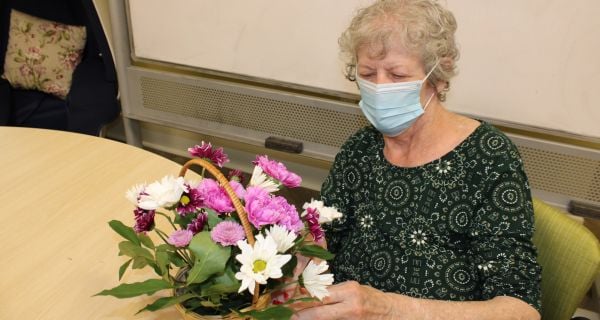 senior woman working on floral arrangement