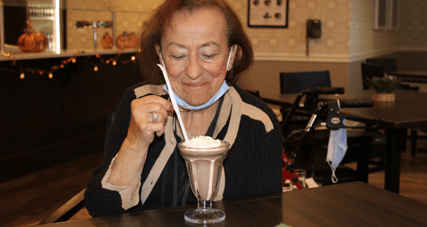 senior woman holding milkshake
