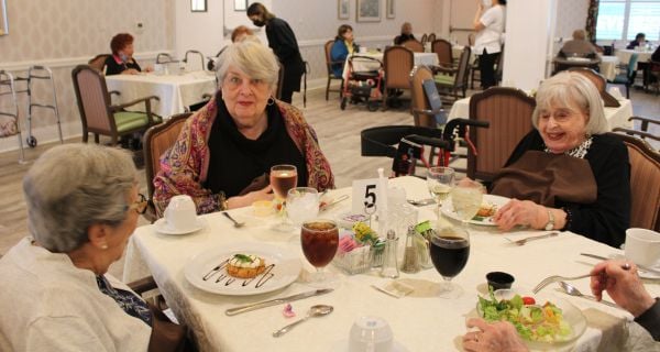 a group of senior women seated a dinner table