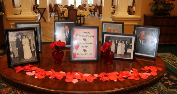 table with photos of anniversary couple