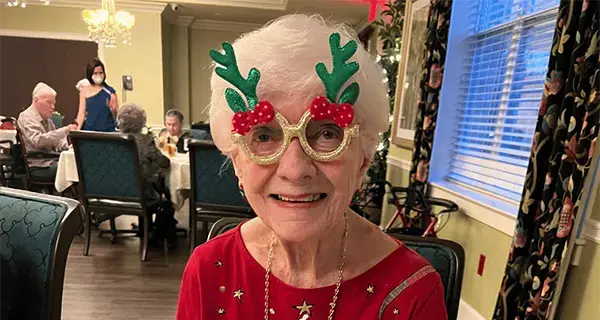 Senior woman wearing Christmas-themed costume glasses