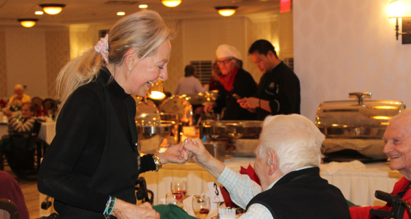 Residents dance together at the Holiday Gala