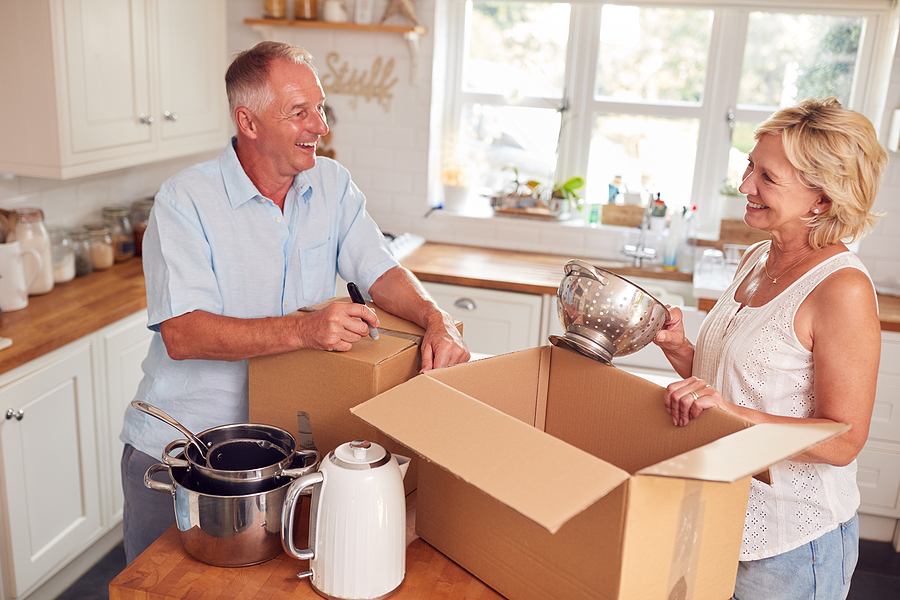 Couple packs up kitchen supplies before moving to senior living