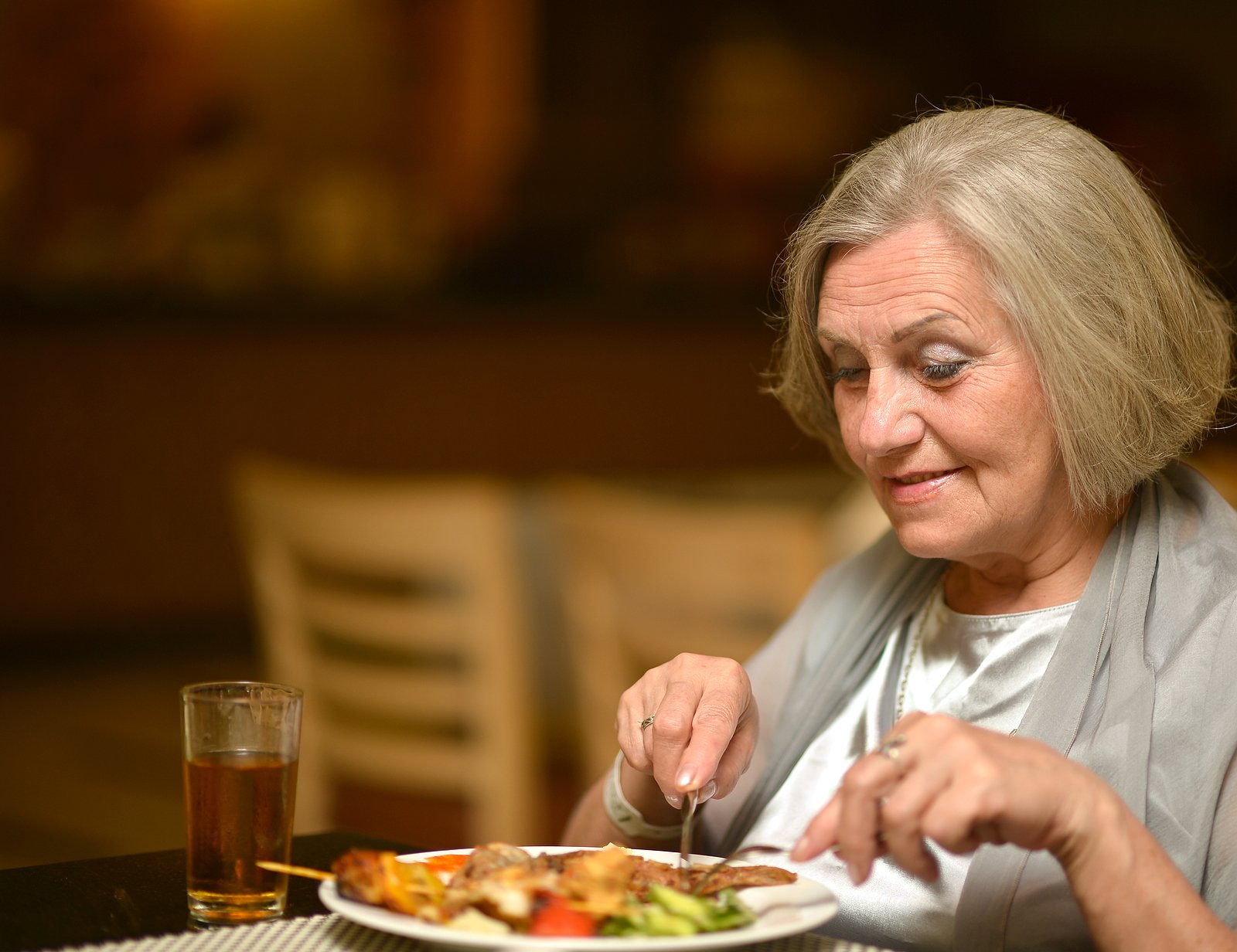 Older woman eating dinner