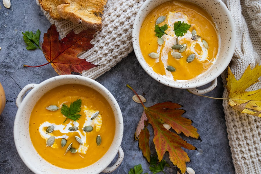 Healthy fall pumpkin soup on a fall-themed table