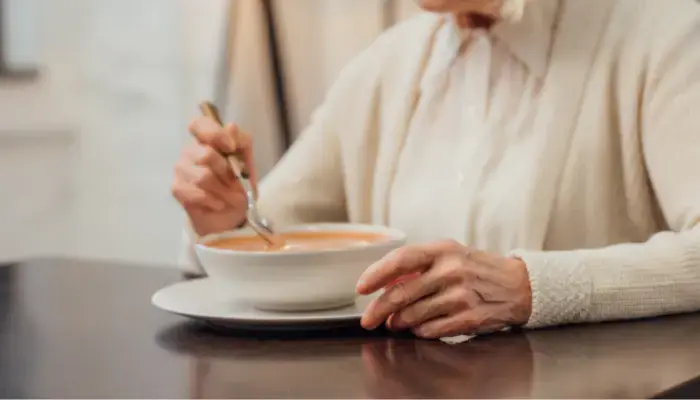 Person with Alzheimer's eating soup