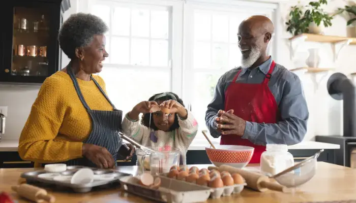 Grandparents baking with their granddaughter