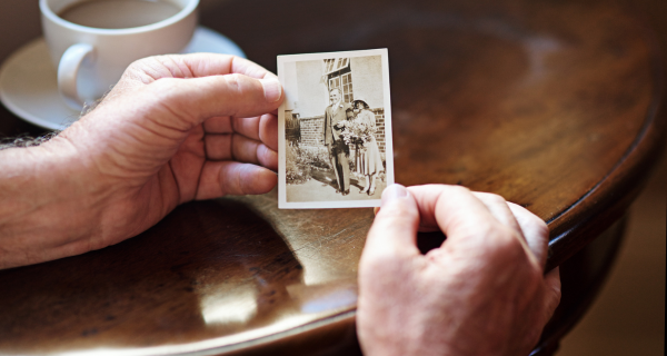 Mature person with dementia looking at an old family photo.