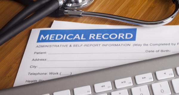 Medical record paper with keyboard and stethoscope.