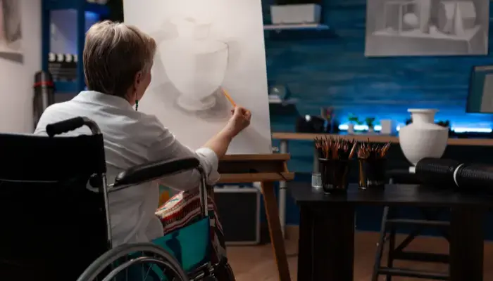 Woman in wheelchair drawing a picture
