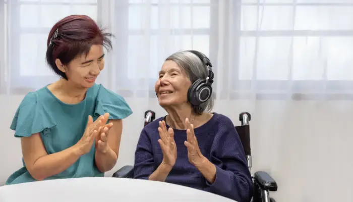 Senior woman with adult child listening to music