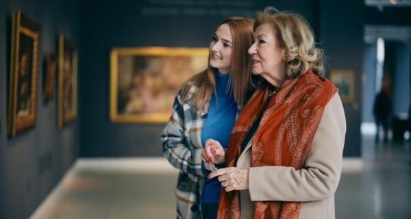 Senior woman with her daughter at an art museum.