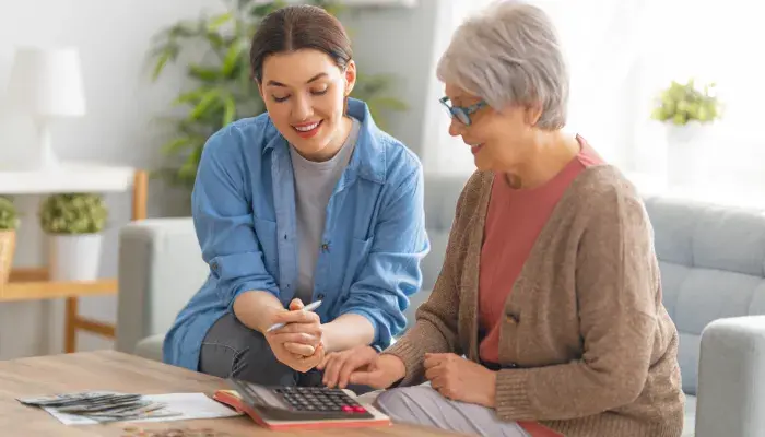 Senior woman discussing finances with adult child