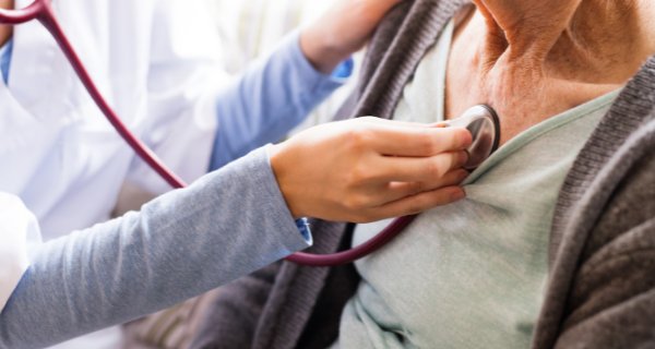 Senior woman having her heart listened to at a check-up.