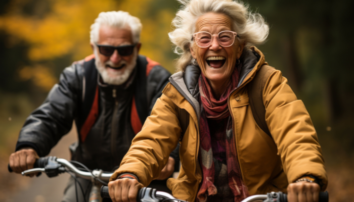 Mature couple joyfully riding bikes together